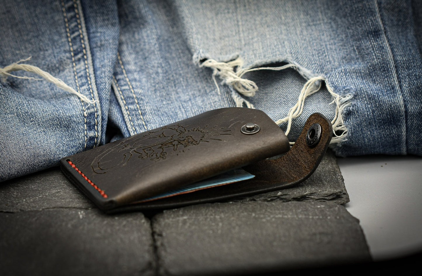 Leather wallet with monkey symbol.