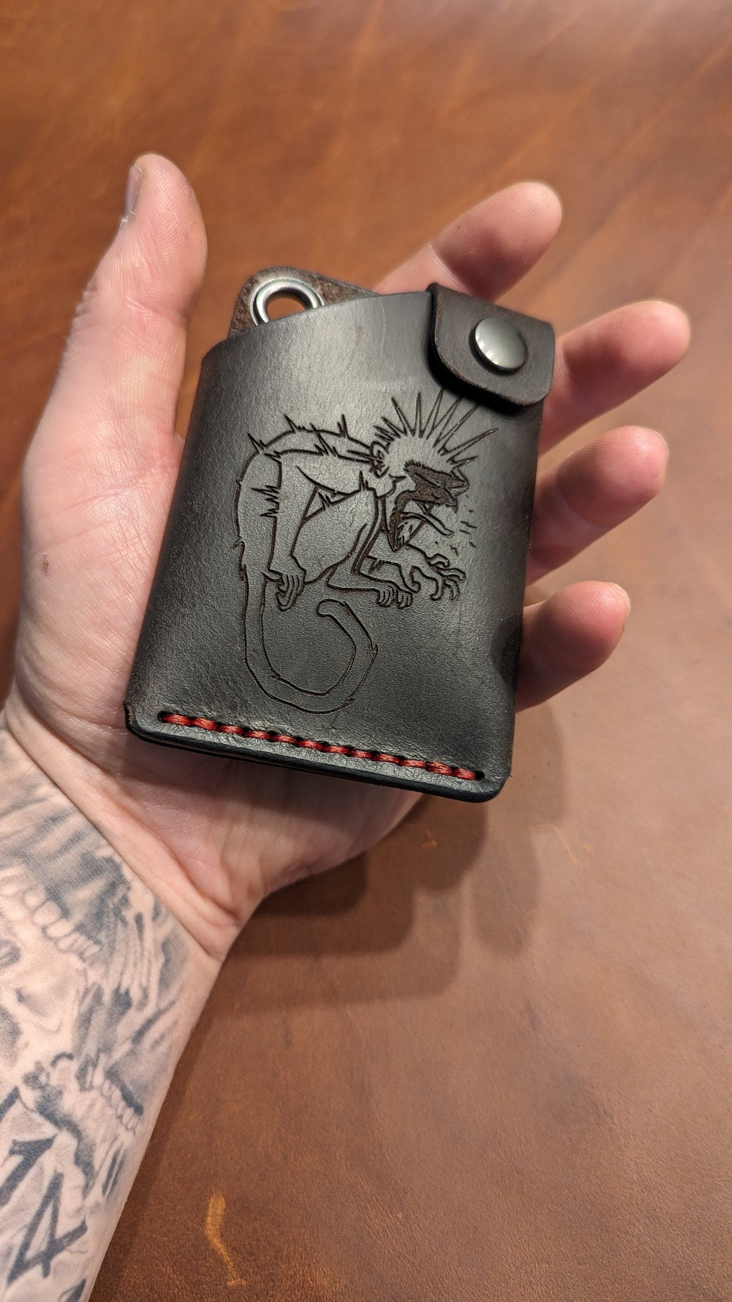 Leather wallet with monkey symbol.