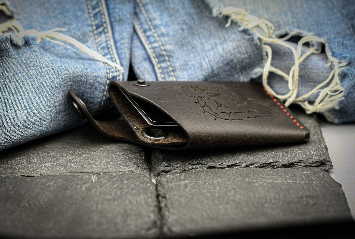 Leather wallet with monkey symbol.