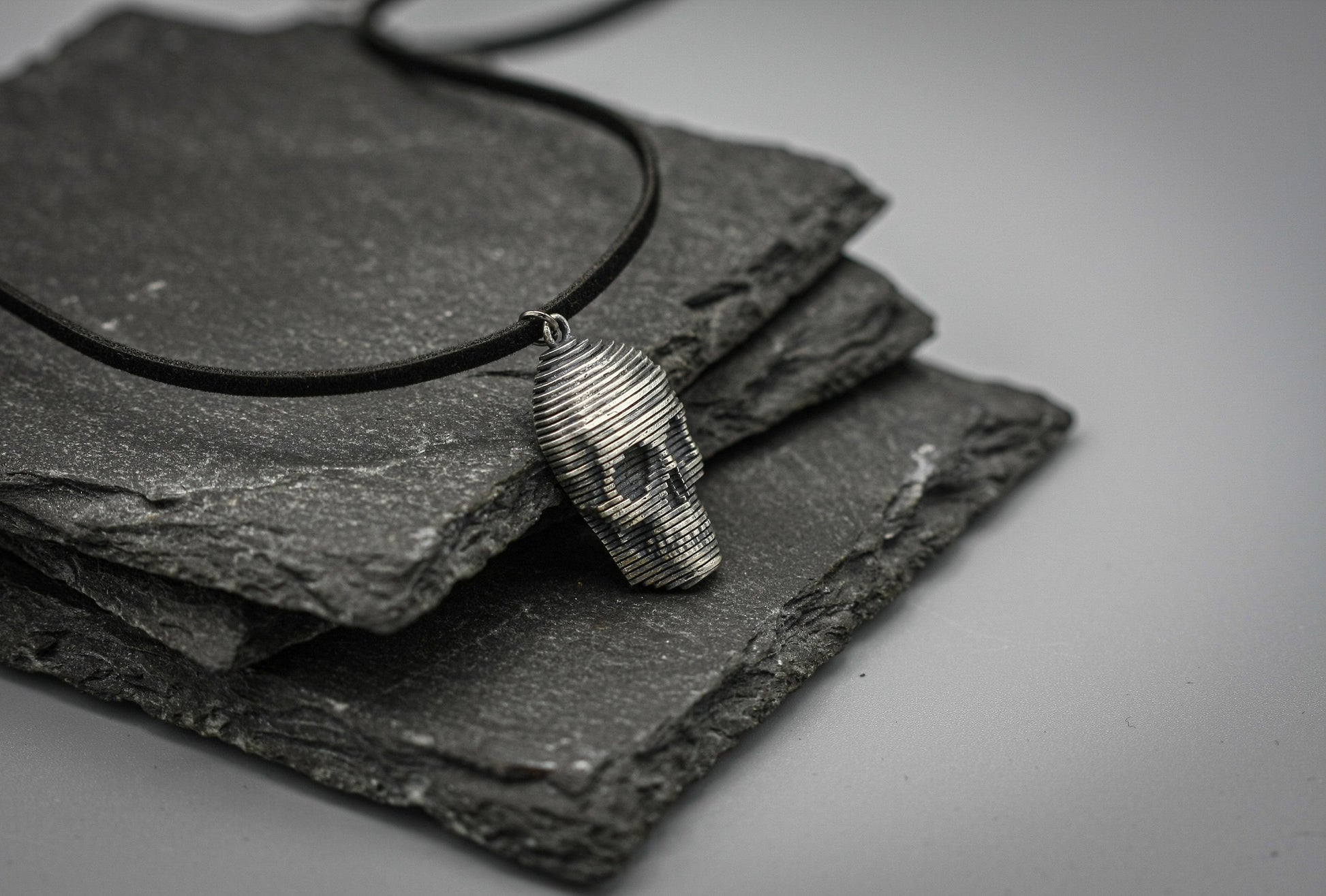 Sliced silver skull pendant.