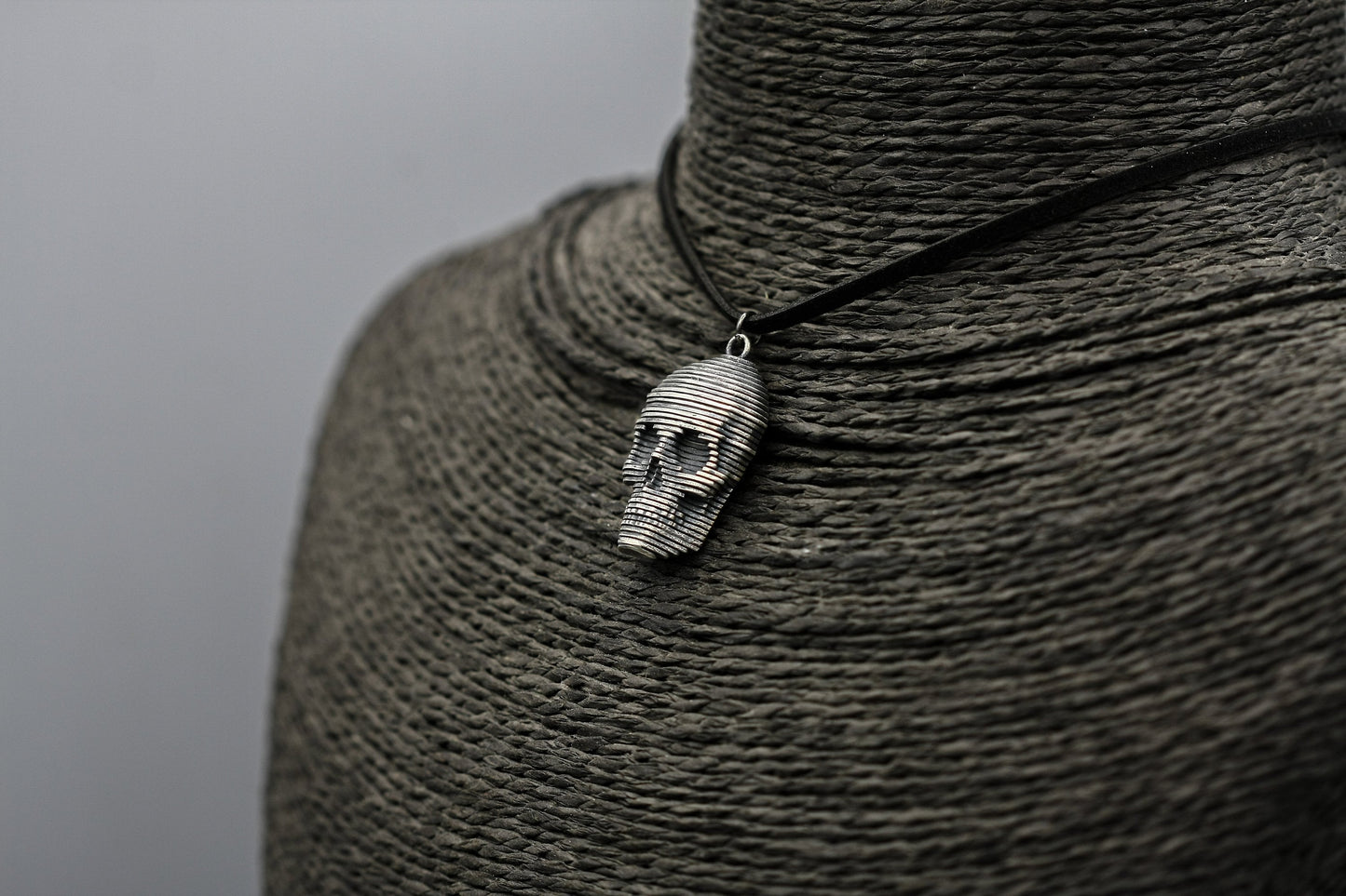 Sliced silver skull pendant.