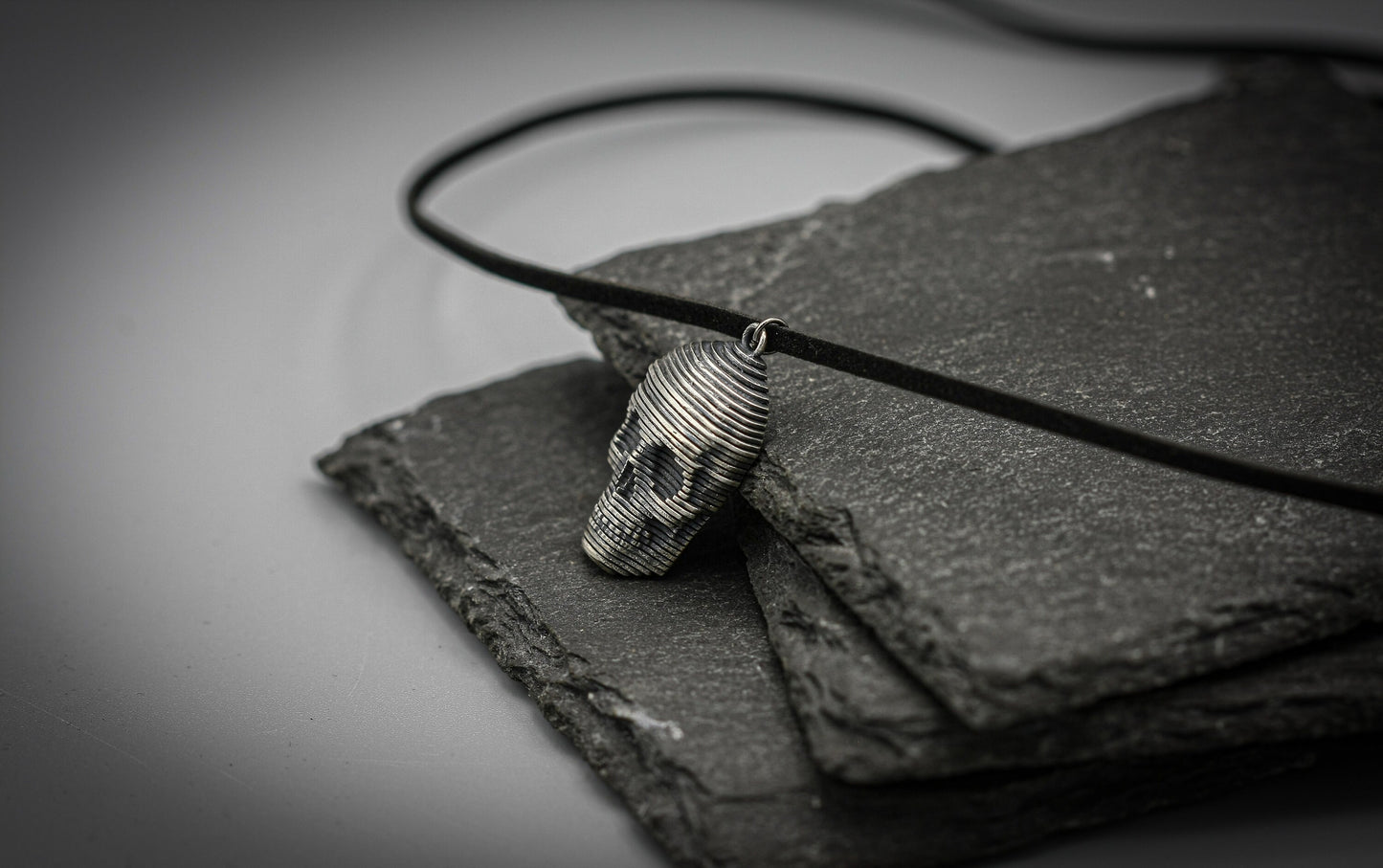 Sliced silver skull pendant.