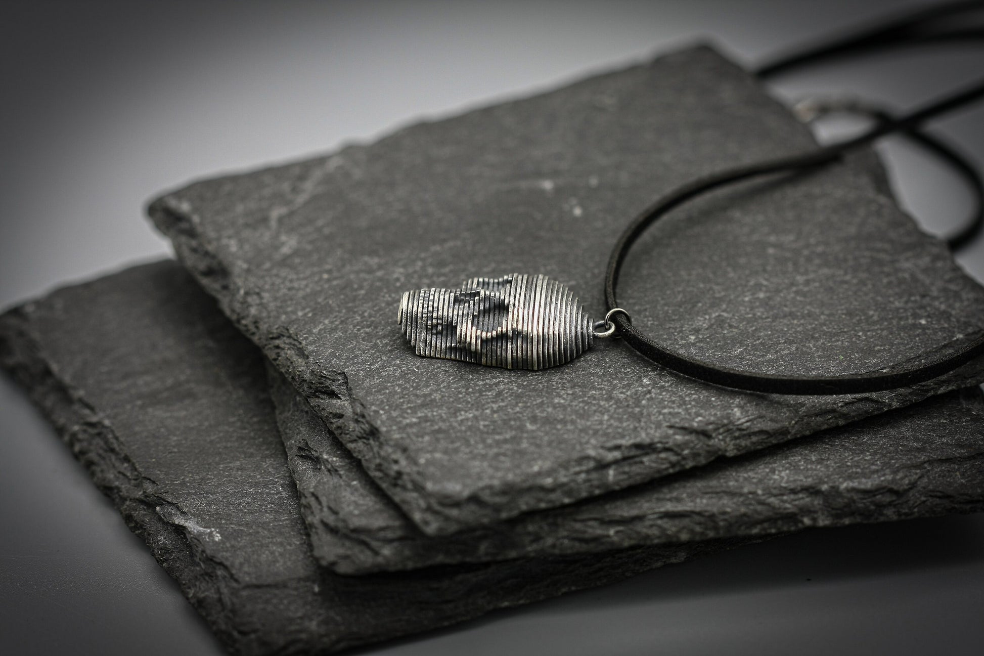 Sliced silver skull pendant.