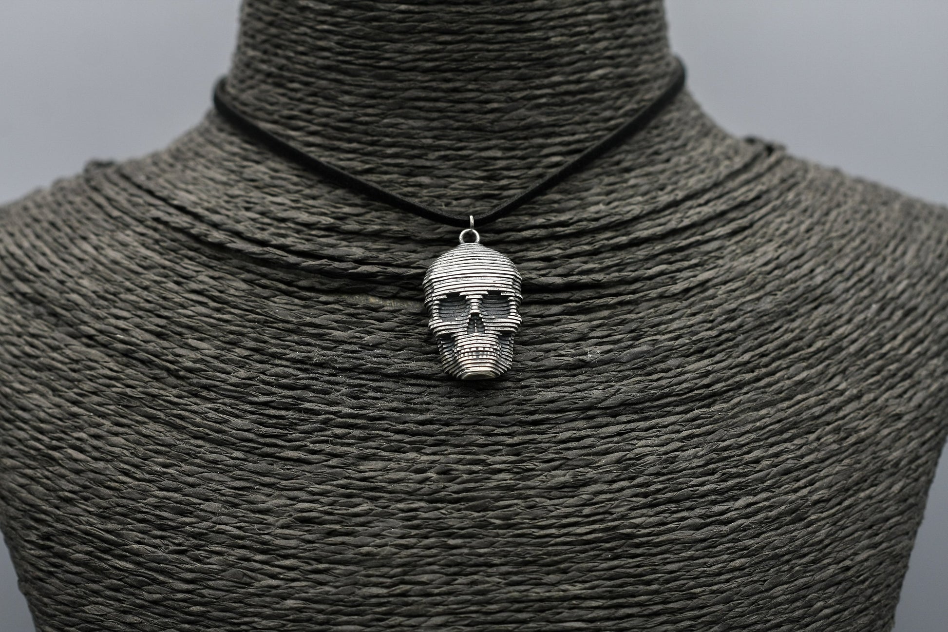 Sliced silver skull pendant.