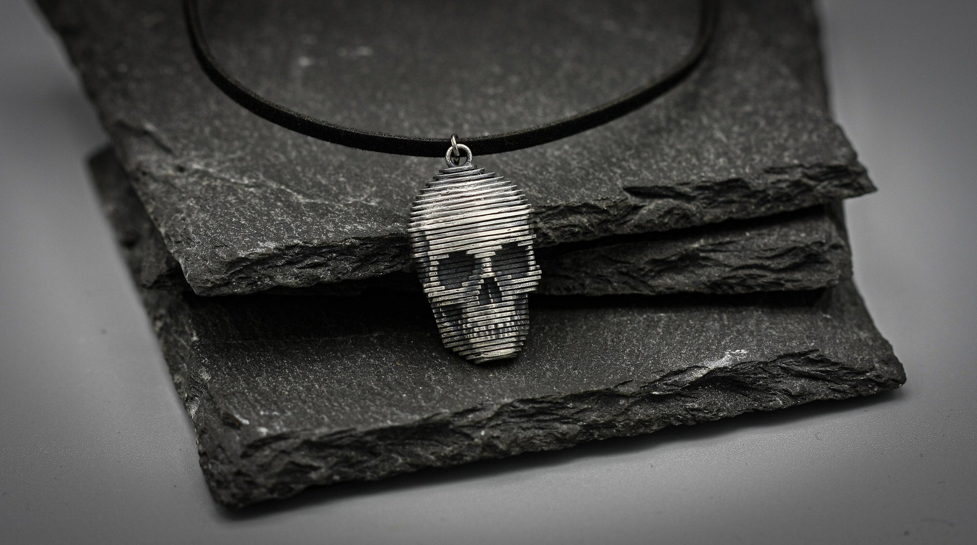 Sliced silver skull pendant.