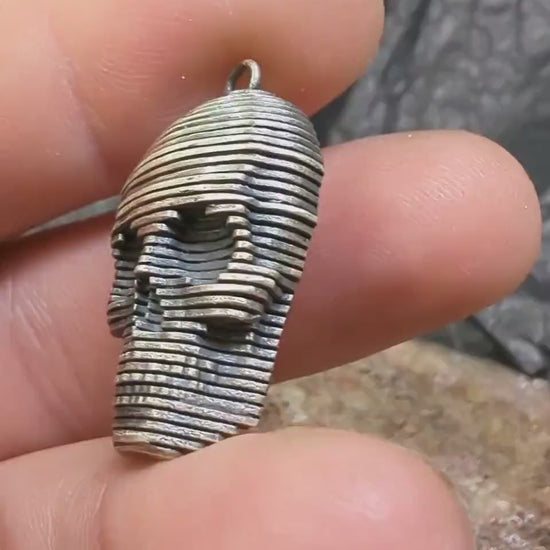 Sliced silver skull pendant.