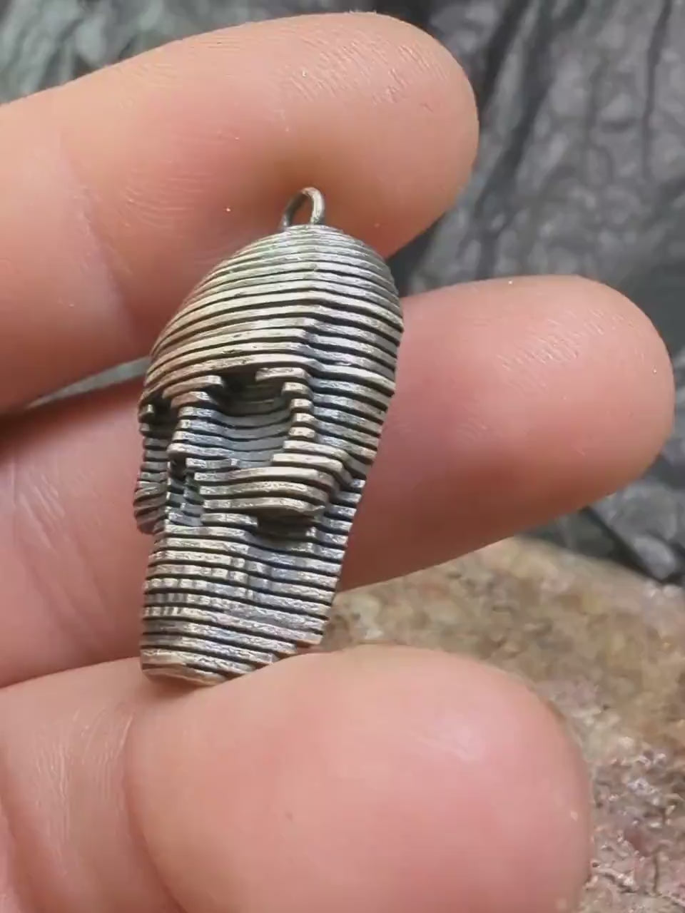 Sliced silver skull pendant.